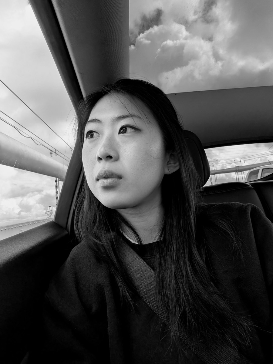 Elizabeth in the back seat of a car, looking out the window